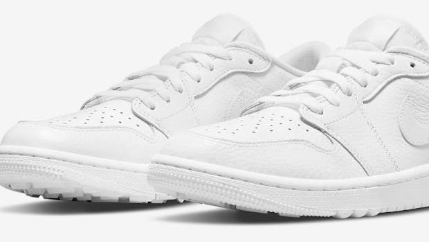 Side view of white Air Jordan golf shoes.